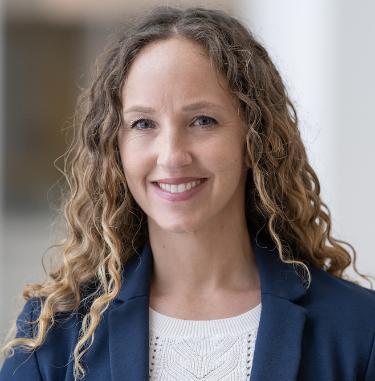 Profile picture of Courtenay Griffin wearing a cream blouse and navy blazer.